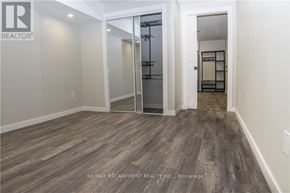 Haldimand apartment for rent - A room with a wooden floor and a glass door leading to another room.