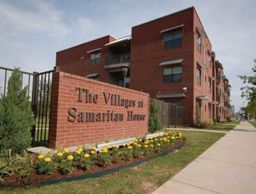 Fort Worth apartment for rent - The Village at Samaritan House is a red brick building with a sign in front.