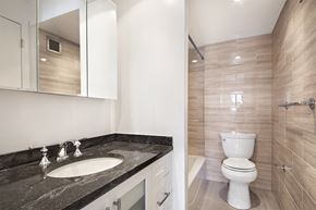 New York apartment for rent - a bathroom with a toilet and a sink and a mirror