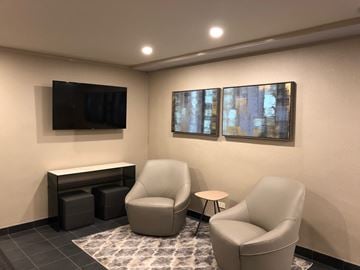 New York apartment for rent - a small living room with two chairs and a television