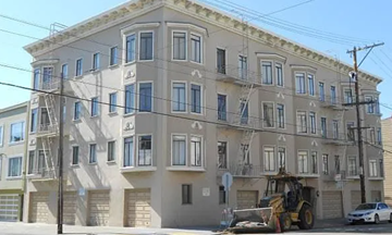 San Francisco apartment for rent - A building with a tractor parked in front of it.