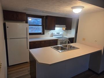 Massillon apartment for rent - A kitchen with a white fridge and a white counter top.