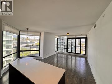 Burnaby apartment for rent - A kitchen with a counter top and a window overlooking a cityscape.