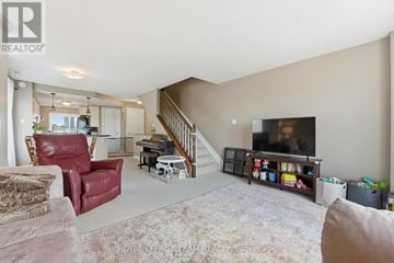 Ottawa townhouse for rent - A living room with a red chair and a television.