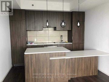 Toronto (Bay Street Corridor) condo for rent - A kitchen with wooden cabinets and a countertop.