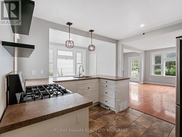 Fort Erie (Ridgeway) apartment for rent - A kitchen with a stove top oven and a counter top.