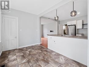 Fort Erie (Ridgeway) apartment for rent - A kitchen with white cabinets and a tile floor.