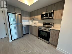 Toronto (Yorkdale-Glen Park) condo for rent - A kitchen with a refrigerator, oven, and microwave.
