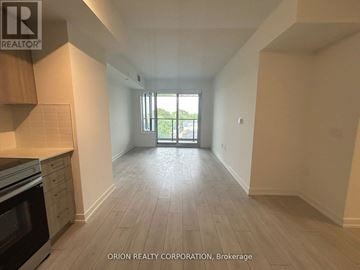 Toronto (Yorkdale-Glen Park) condo for rent - A kitchen area with a stove top oven and a large open door leading to a balcony.