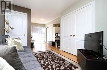 Brampton (Downtown Brampton) townhouse for rent - A living room with a grey couch and a black television.
