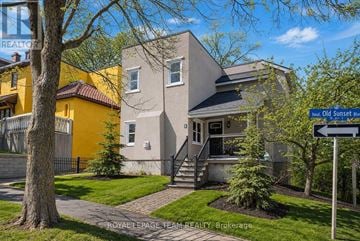 Ottawa apartment for rent - A house with a sign that says "Bud Old Sunset Blvd" in front of it.