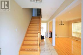Toronto (Rouge) apartment for rent - A wooden staircase with a chandelier above it.