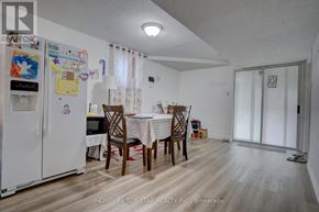 Toronto (Guildwood) apartment for rent - A kitchen with a refrigerator, table and chairs.