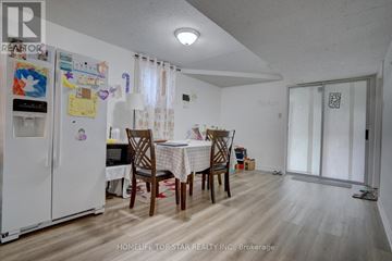 Toronto (Guildwood) apartment for rent - A kitchen with a refrigerator, table and chairs.