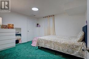 Toronto (Guildwood) apartment for rent - A bedroom with a bed, dresser, and window with curtains.