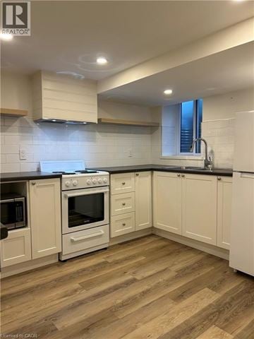 Hamilton apartment for rent - A kitchen with white cabinets and a black countertop.