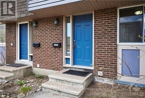 Ottawa townhouse for rent - A house with a blue door and a sign that says "REALTOR".