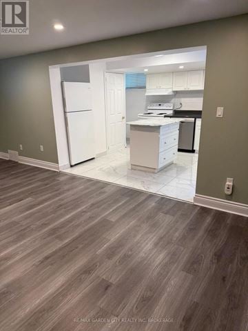 Welland (N. Welland) apartment for rent - A kitchen with white appliances and a white refrigerator is shown.