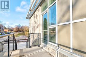 Waterloo condo for rent - A building with a glass door and windows is shown.