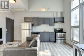 Waterloo condo for rent - A modern kitchen with a refrigerator, oven, and stove.