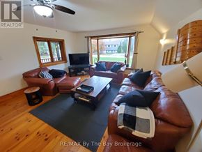 Collingwood apartment for rent - A living room with brown leather couches and a black coffee table.