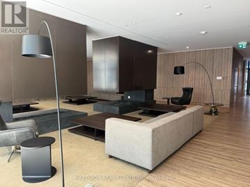 Toronto (Waterfront Communities) condo for rent - A modern living room with a white sofa and a wooden floor.