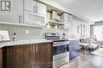 Brampton (Northwest Brampton) townhouse for rent - A kitchen with a stove top oven and a microwave above it.