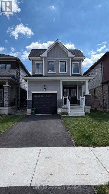 Brantford apartment for rent - A two-story house with a garage is located in a residential area.