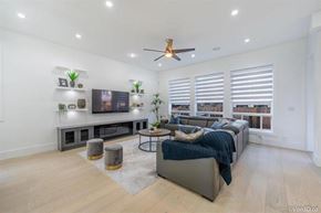Surrey apartment for rent - A living room with a grey couch and a television on a stand.