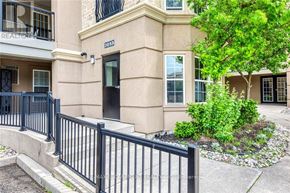 Burlington (Uptown) condo for rent - A black fence surrounds a beige building with the number 2055 on it.