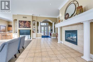 Burlington (Uptown) condo for rent - A living room with a fireplace and a painting on the wall.