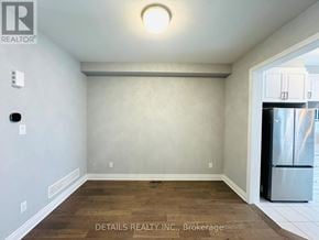 Ottawa townhouse for rent - A room with a refrigerator and a light on the ceiling.