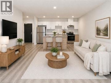 Guelph condo for rent - A modern living room with a wooden coffee table and a white sofa.