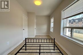 Toronto (Danforth) apartment for rent - A bedroom with a bed in the middle of the room.