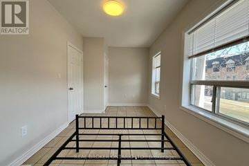 Toronto (Danforth) apartment for rent - A bedroom with a bed in the middle of the room.