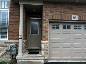 Hamilton townhouse for rent - A grey door is on the right of a brick house with a number 96 on the wall.