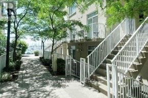 Toronto (Niagara) townhouse for rent - A white staircase is in front of a building.