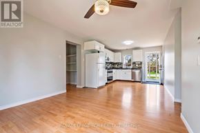Orangeville apartment for rent - A well-lit, spacious kitchen with wooden floors and white walls.