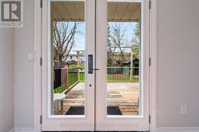 Orangeville apartment for rent - A white door with a glass window and a Royal LePage REALTY sign on it.