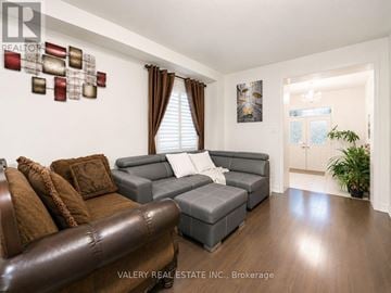 Brampton (Northwest Brampton) apartment for rent - A living room with a brown leather couch and a grey sofa.