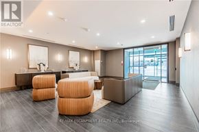 Hamilton (Waterdown) condo for rent - A spacious living room with a grey floor and a white ceiling.