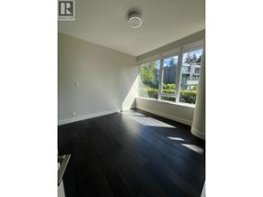 West Vancouver apartment for rent - A room with a large window and wooden flooring.
