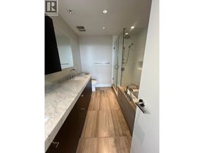 West Vancouver apartment for rent - A bathroom with a marble countertop and wooden flooring.