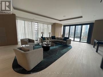 Toronto (North St. James Town) condo for rent - A living room with a large couch and a coffee table.