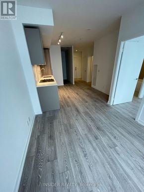 Toronto (Waterfront Communities) condo for rent - A modern kitchen with wooden flooring and a sink.