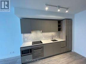 Toronto (Waterfront Communities) condo for rent - A modern kitchen with a stainless steel oven and microwave.
