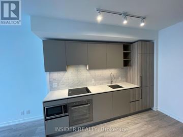 Toronto (Waterfront Communities) condo for rent - A modern kitchen with a stainless steel oven and microwave.