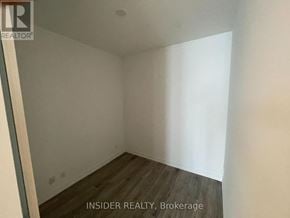 Toronto (Waterfront Communities) condo for rent - A room with wooden flooring and white walls.