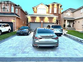 Whitby (Rolling Acres) apartment for rent - A car is parked in front of a house with a brick facade.