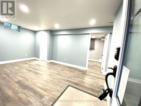 Whitby (Rolling Acres) apartment for rent - A room with wooden flooring and a glass door.